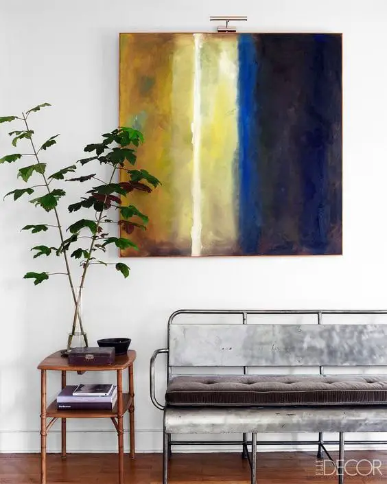 Simple entryway decor with abstract art and vintage bench via @thouswellblog