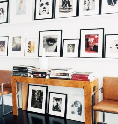 AN INCREDIBLE TOWNHOUSE FULL OF ART 1 Burl console table with floating art shelves gallery wall on Thou Swell @thouswellblog #gallerywall #artwall #artshelves #art #photography #artcollection #homedecor #homedecorideas #design