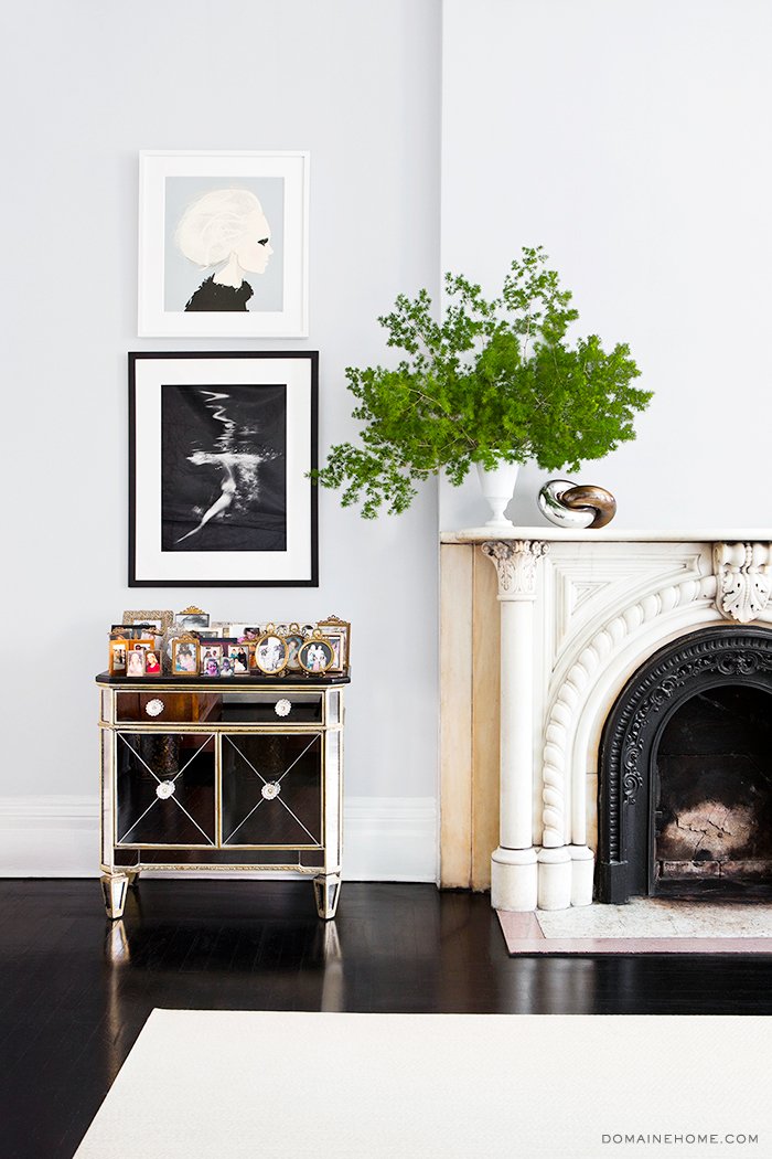 Mirrored table next to ornate fireplace mantel on Thou Swell @thouswellblog