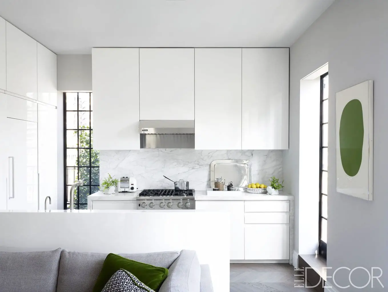 A sleek modern all-white kitchen in a New York City penthouse.