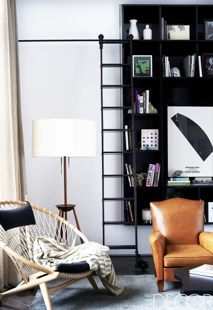 Corner vignette of Johnny Buckland's ultra-cool Manhattan pad, with modern built-in shelves and leather armchair.