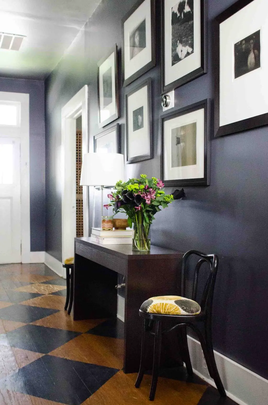 Moody charcoal entry hallway with black and white gallery wall