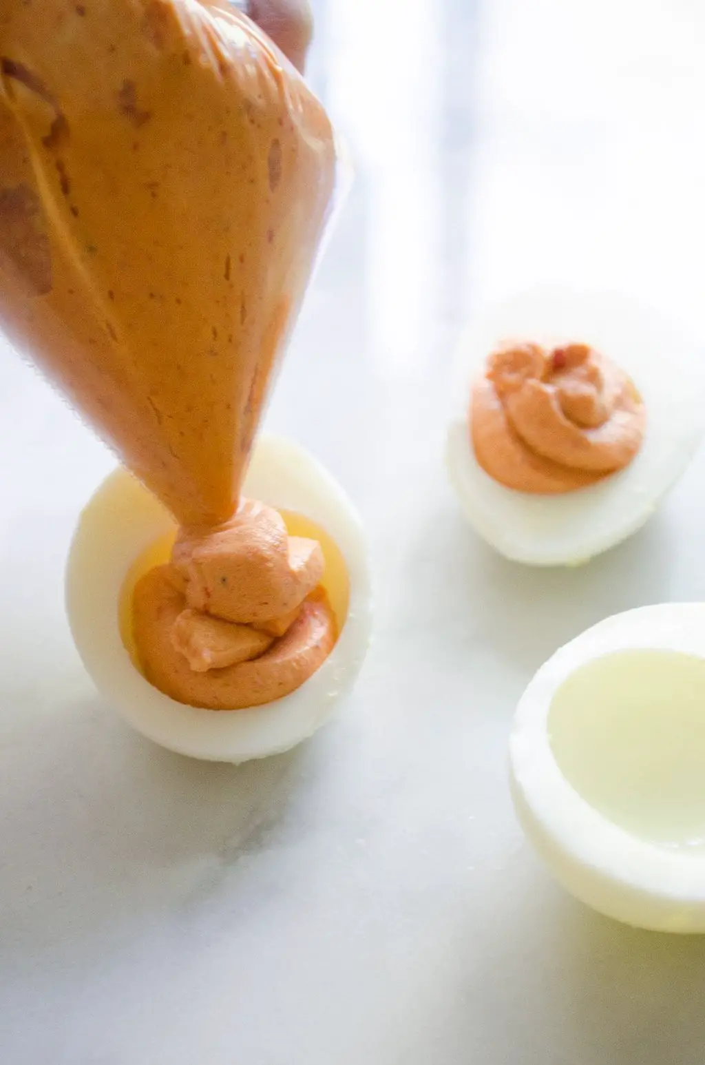 Roasted Piquillo Pepper Deviled Eggs recipe via @thouswellblog
