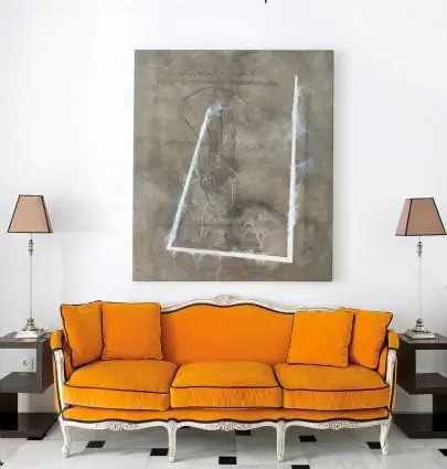 Bold orange sofa upholstery in entryway with marble floor and abstract painting in Spain on Thou Swell #hometour #spanishhome #eclecticstyle #interiordesign #spanishdesign #homedesign #housetour #spanishstyle #homedecorideas