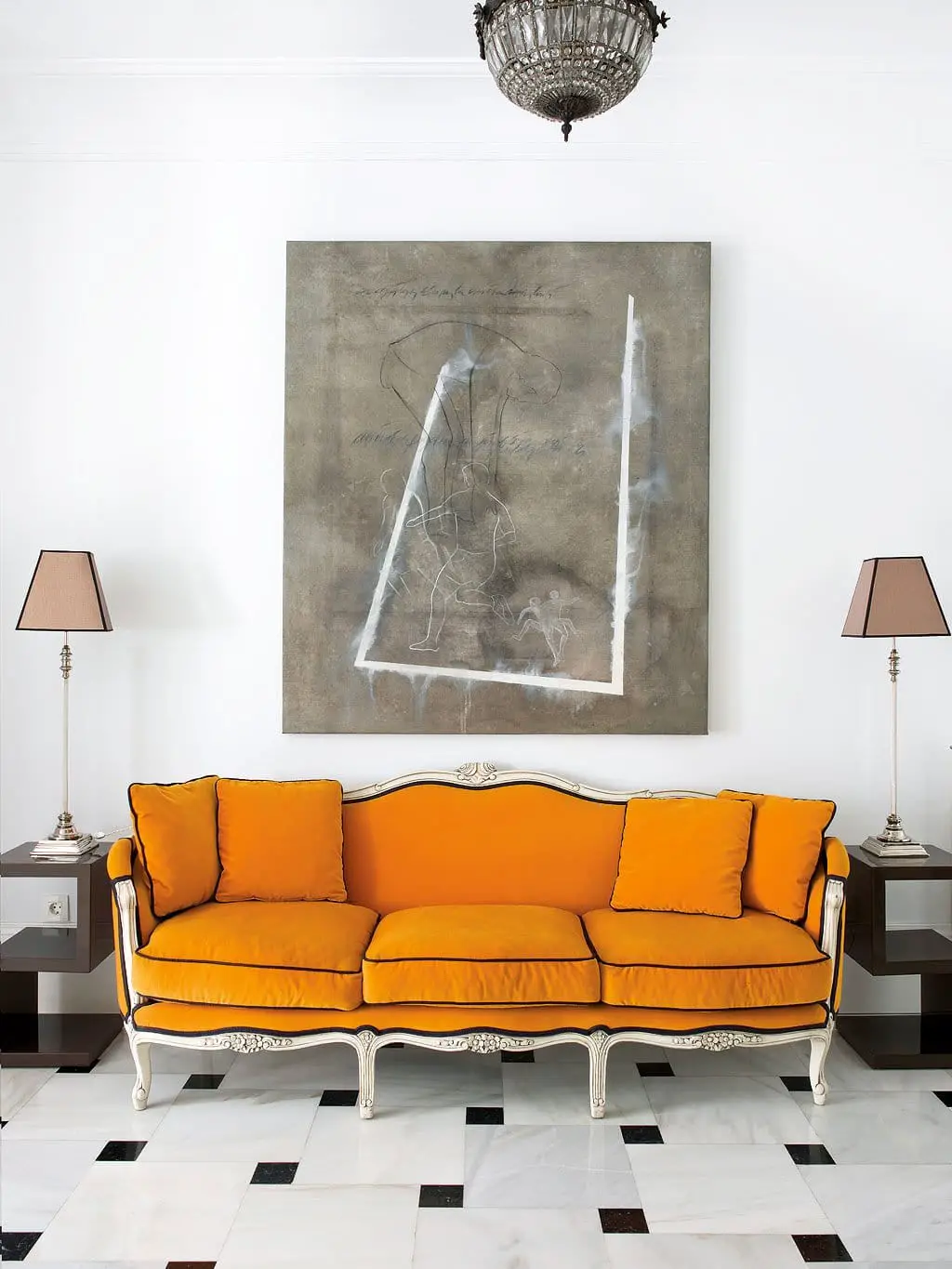 Orange sofa in an entryway with marble floors via @thouswellblog
