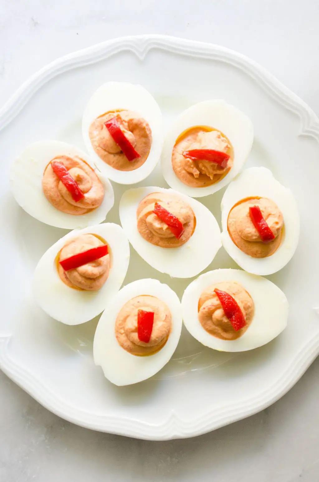 Mayonnaise-free roasted piquillo pepper deviled eggs recipe via @thouswellblog