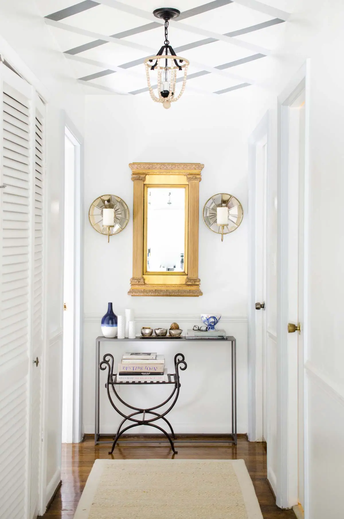 Hallway makeover with gold mirror and lattice ceiling stripes via @thouswellblog