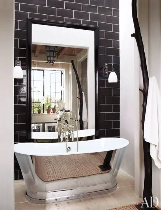 Modern bathroom with stainless steel bathtub, black subway tiles via @thouswellblog