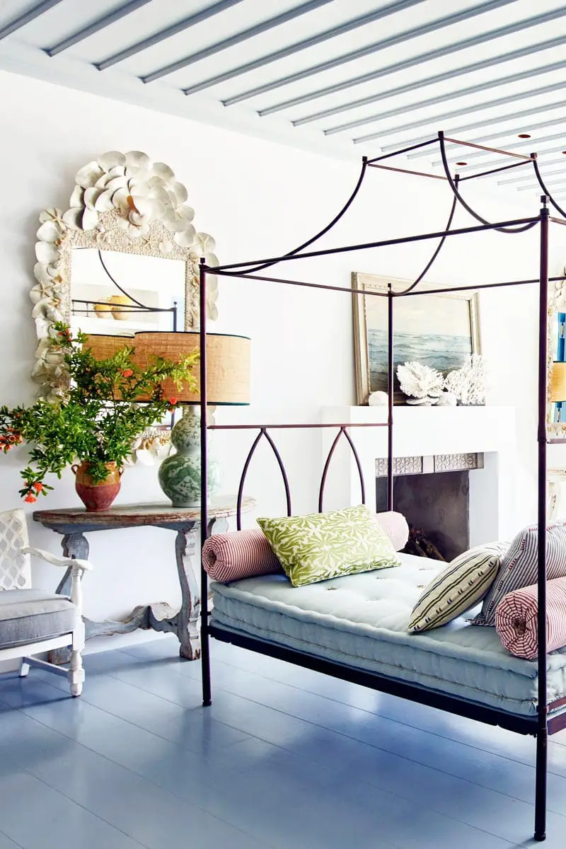 Metal canopy daybed in a Mediterranean living room via @thouswellblog