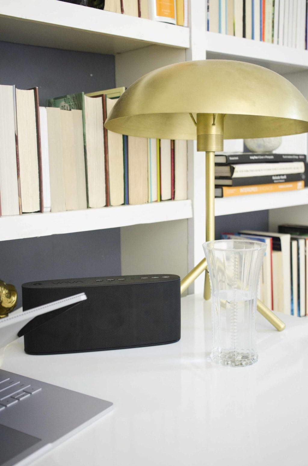 Modern standing desk home office with bookshelves on @thouswellblog