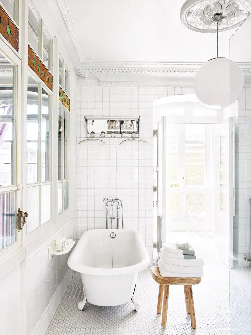 Clean white tile bathroom in eclectic home via @thouswellblog