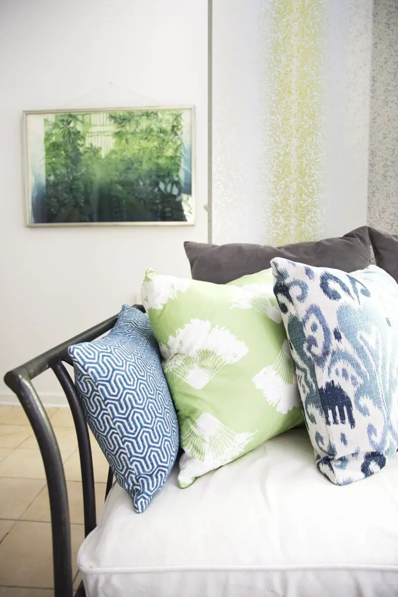 Blue and green throw pillows on bohemian daybed on Thou Swell