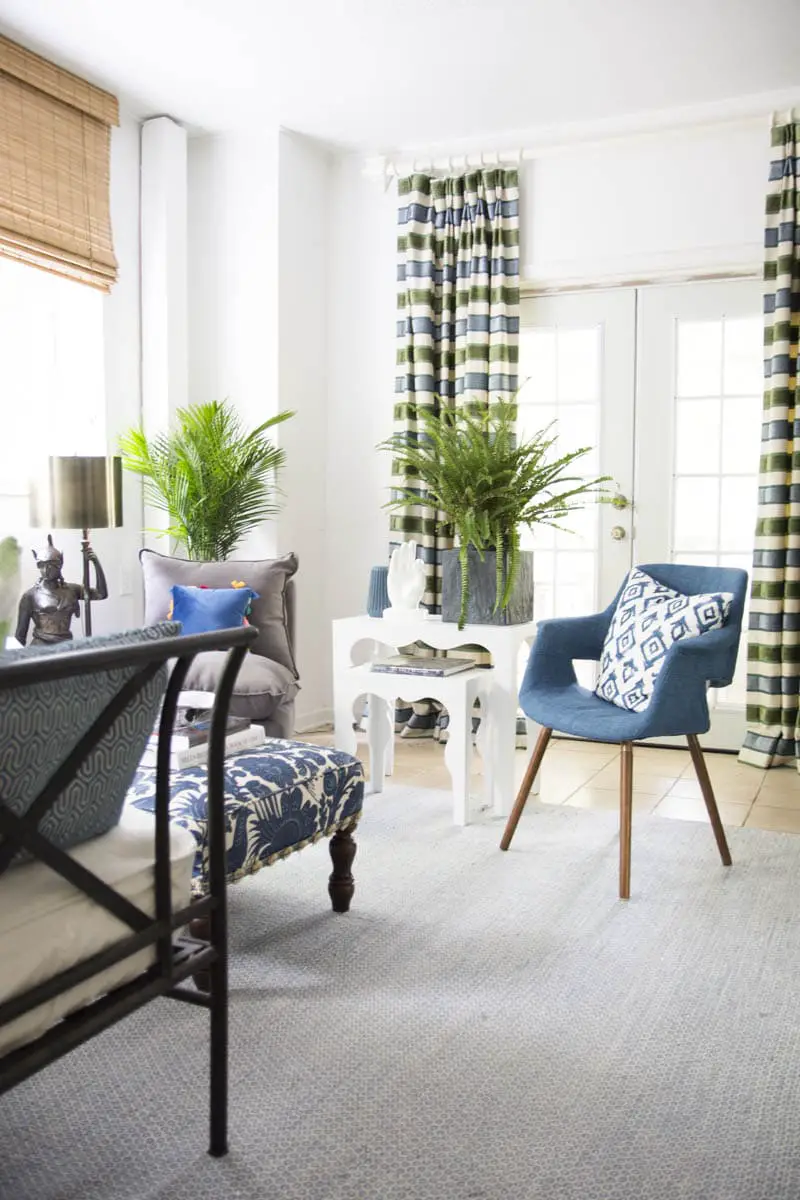 Blue green guest room with fern, palm, and Moroccan side tables on Thou Swell
