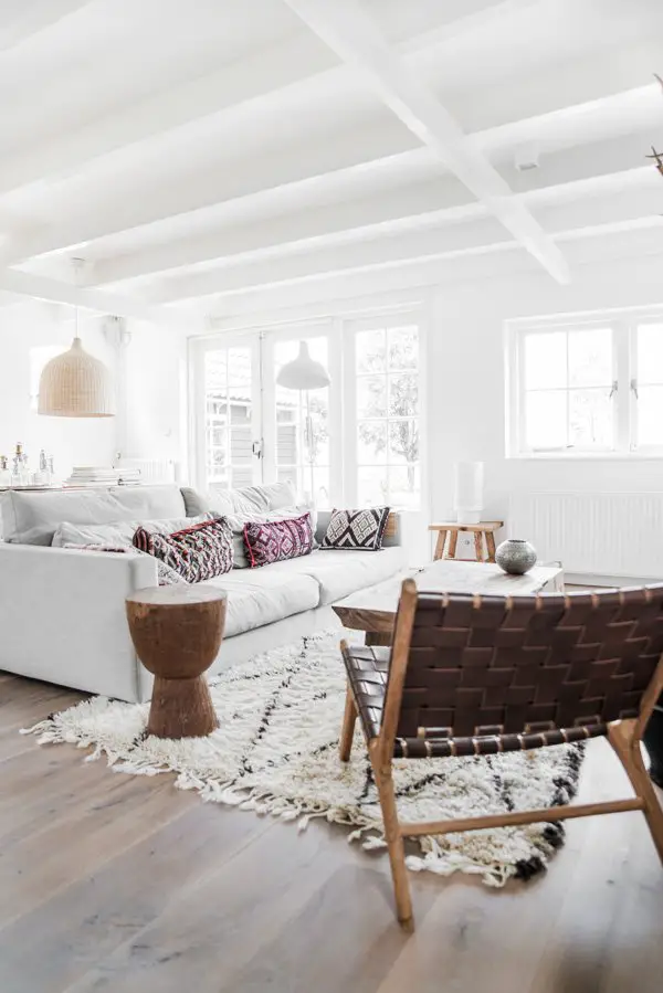 Woven leather lounge chair in white Scandinavian living room on Thou Swell @thouswellblog