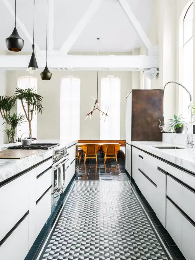 Loft kitchen with tiled floor and modern white cabinetry on Thou Swell @thouswellblog