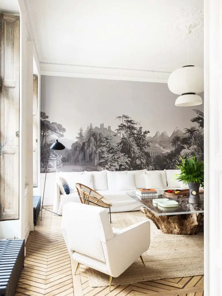 Natural finishes and neutral colors in a modern Paris living room on Thou Swell #livingroom #mural #wallpaper #landscapemural #french #frenchinterior #frenchdesign #interiordesign #livingroomdesign