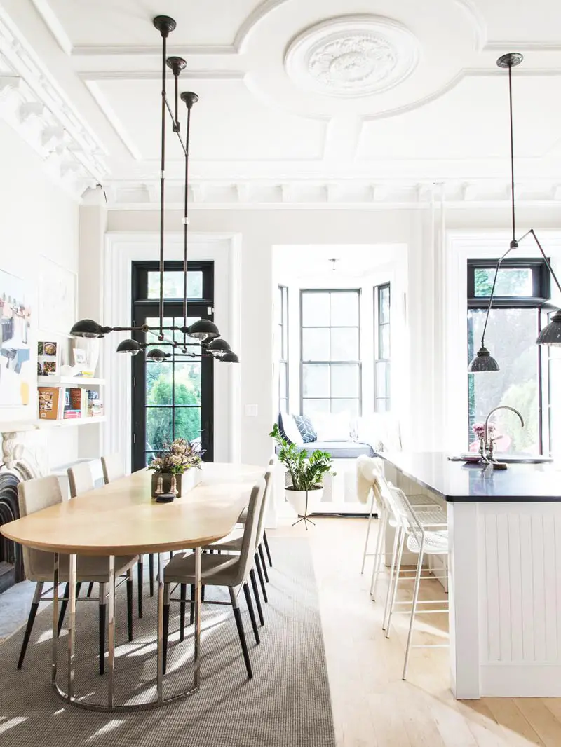 Modern townhouse kitchen with dining table and window seat on Thou Swell @thouswellblog