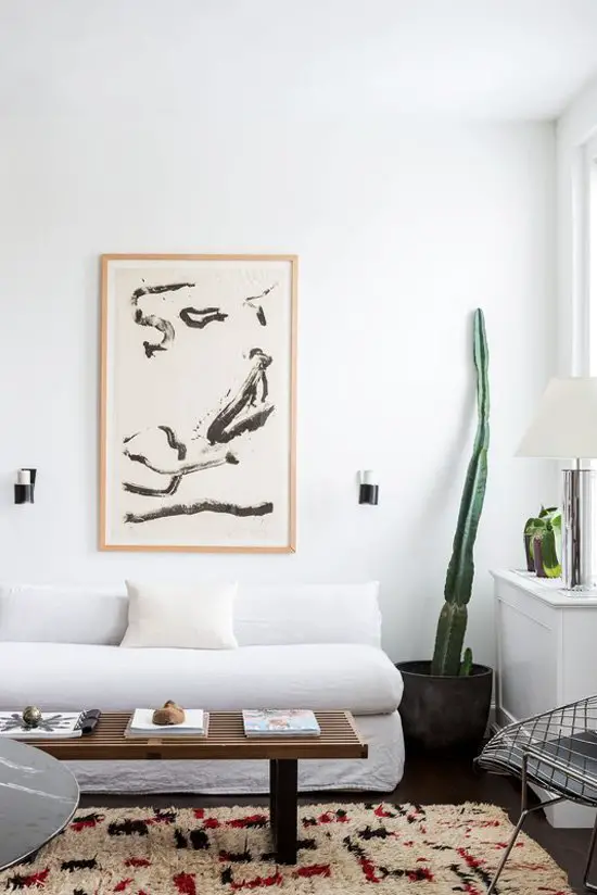 Minimal white living room with cactus in New York City apartment tour on Thou Swell @thouswellblog