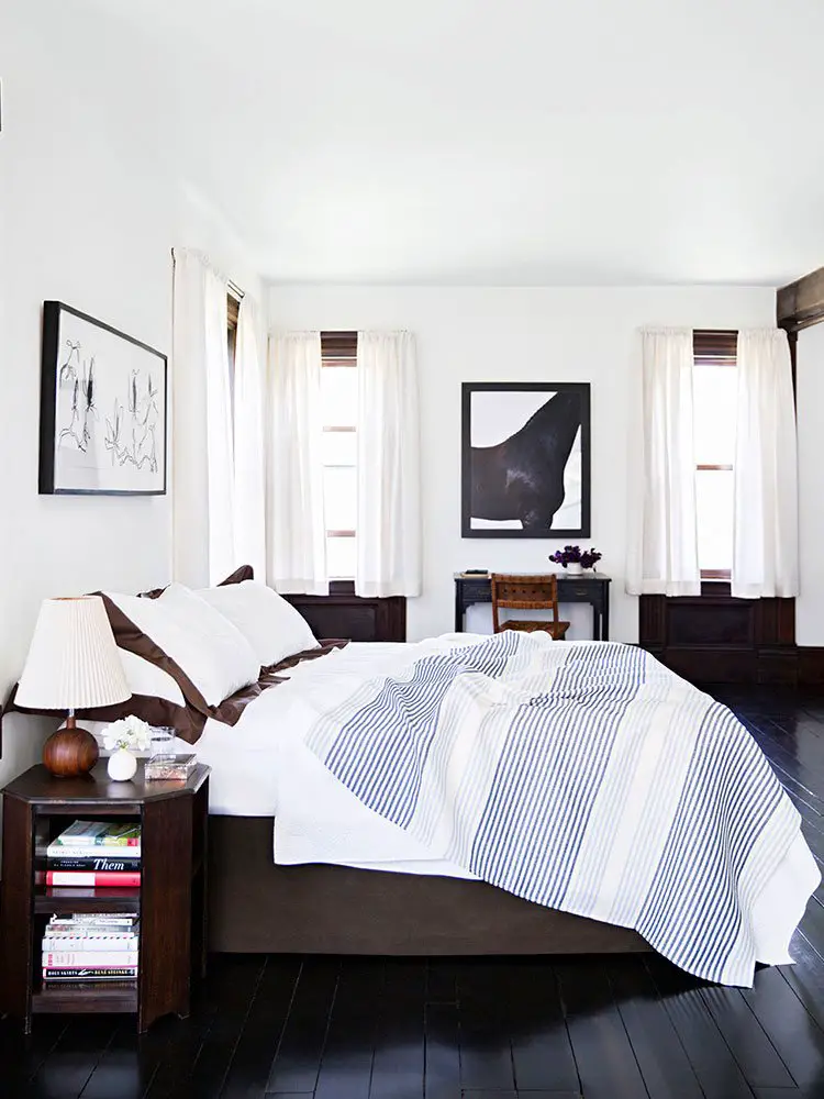 Dark brown and white bedroom with striped coverlet, black and white photography, and black floors - how to choose bedroom lighting on Thou Swell @thouswellblog