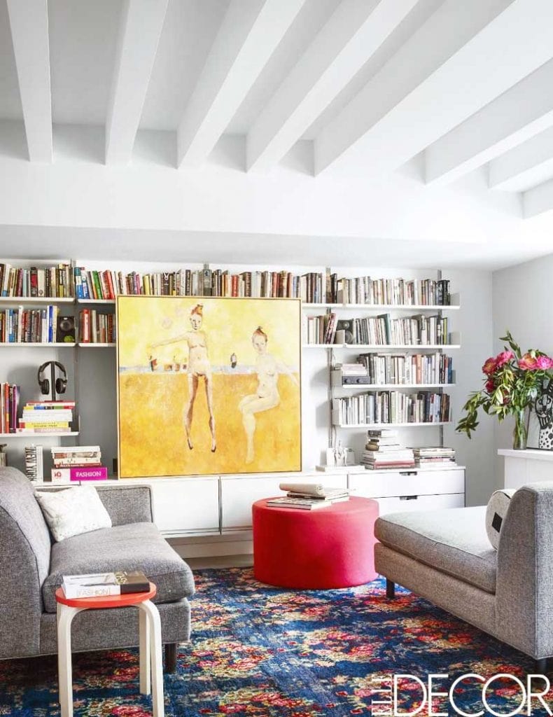 Colorful living room with large yellow painting and red ottoman on Thou Swell @thouswellblog