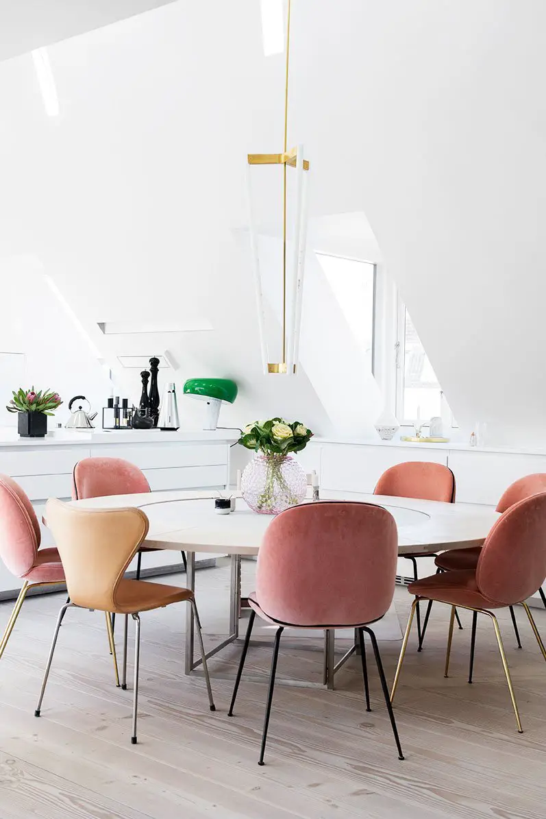 Modern loft dining room with pink velvet chairs and LED light fixture on Thou Swell @thouswellblog