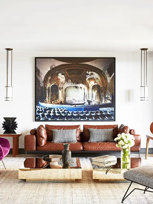 A glamorous Monaco living room with modern leather sofa and brass coffee tables on Thou Swell @thouswellblog