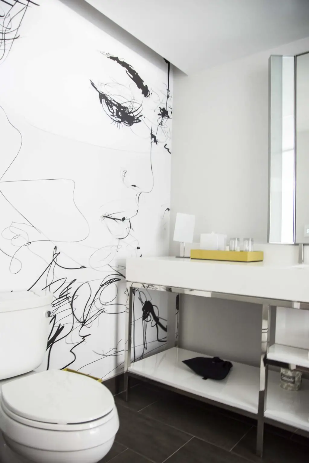 Modern bathroom with black and white mural at the Renaissance airport hotel in Atlanta on Thou Swell @thouswellblog