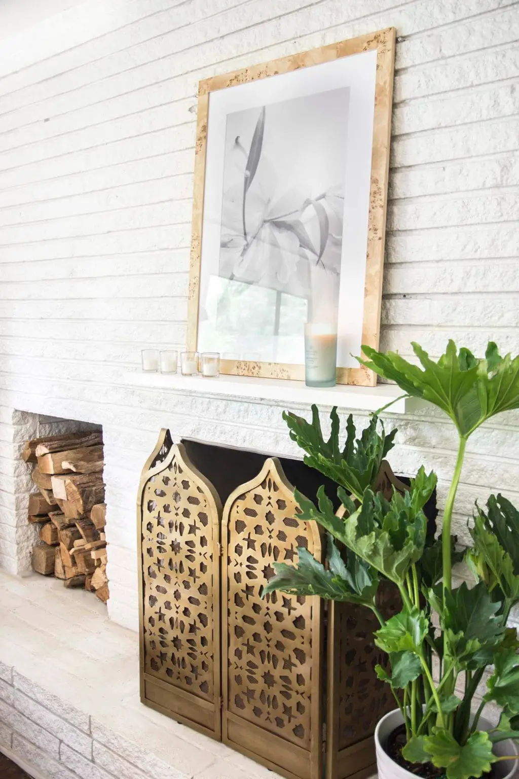 Simple living room white brick fireplace design with Chesapeake Bay Candle on the mantel on Thou Swell @thouswellblog