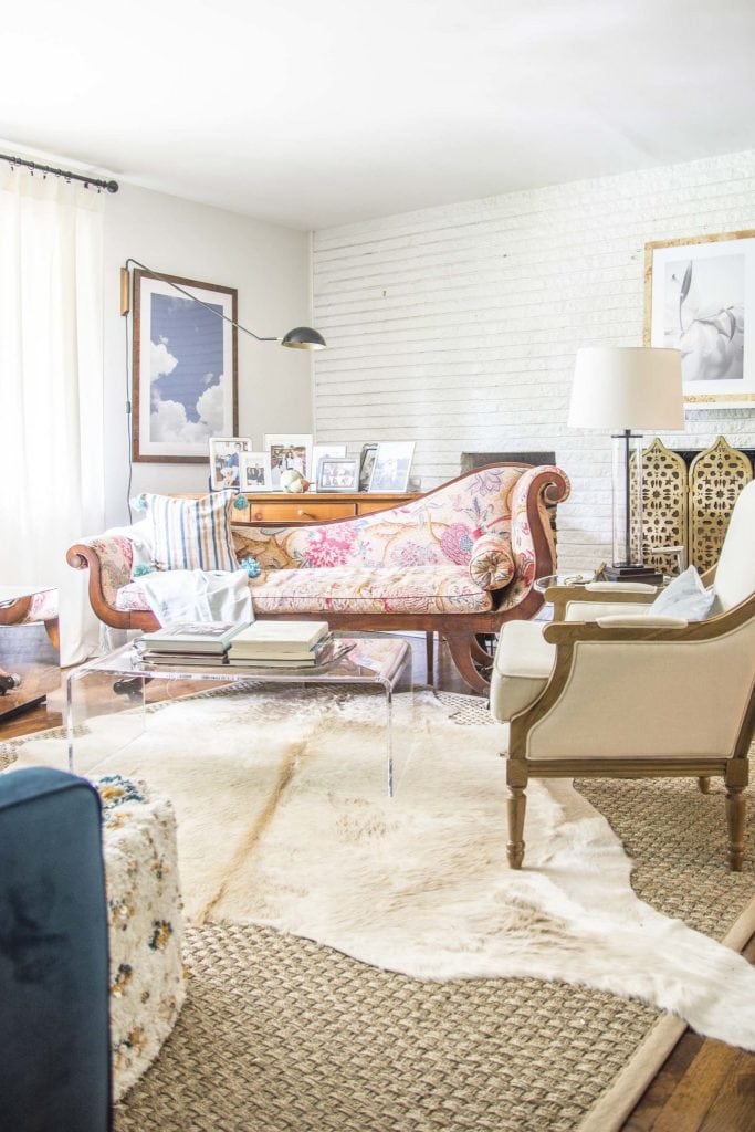 Eclectic living room with layered cowhide and seagrass rug on Thou Swell @thouswellblog