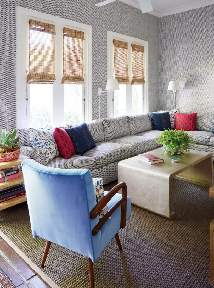 Colorful New Orleans living room with sectional and blue armchair on Thou Swell @thouswellblog