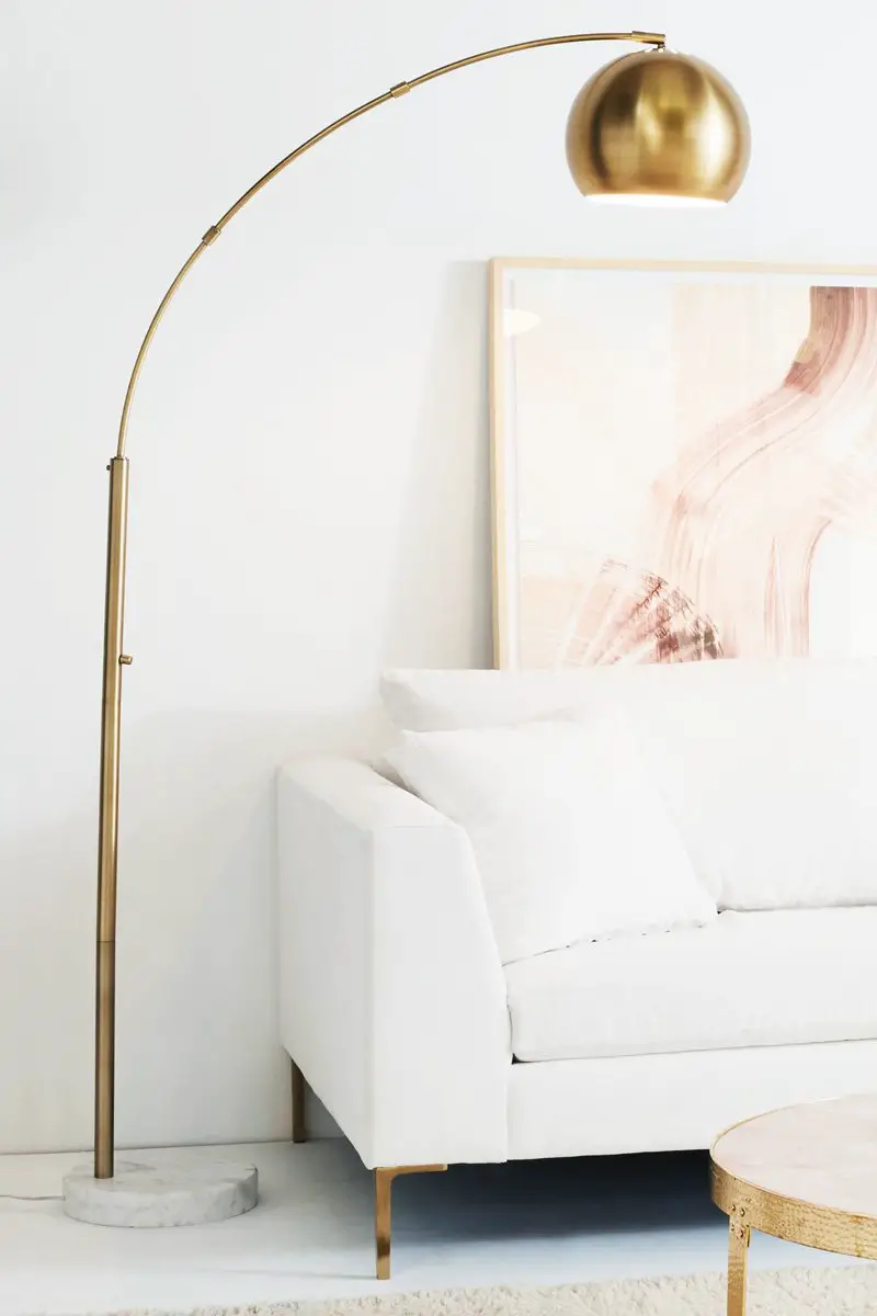 Brass floor lamp and pink wall art in white room on Thou Swell @thouswellblog