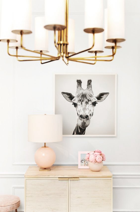 Pink decor in living room with Kate Spade wall decor and brass chandelier on Thou Swell @thouswellblog