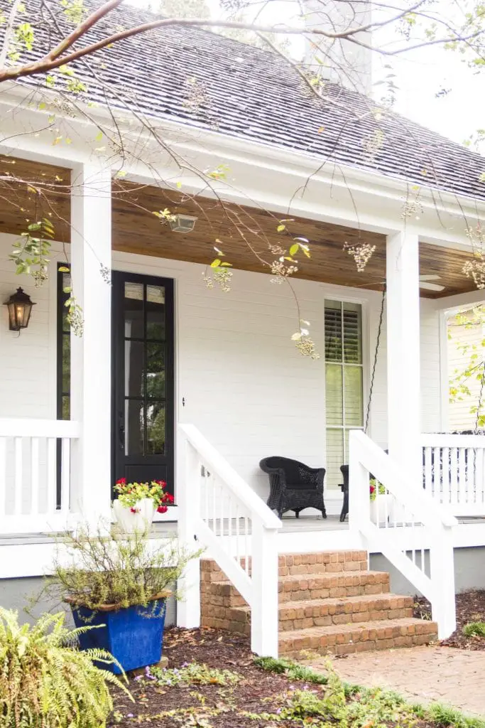 White bungalow with large front porch in sustainable community Serenbe, Georgia on Thou Swell @thouswellblog