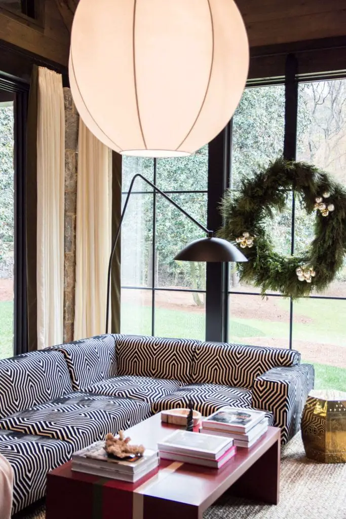 Modern living room with iron windows and holiday wreath on Thou Swell @thouswellblog