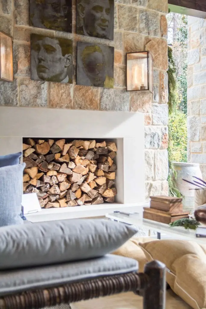 Logs stacked in the outdoor fireplace in covered patio on Thou Swell @thouswellblog
