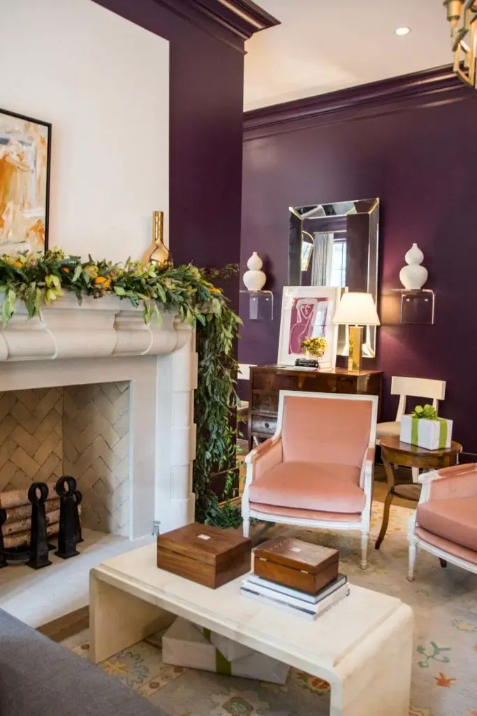 Purple living room walls with holiday garland on the mantel on Thou Swell @thouswellblog