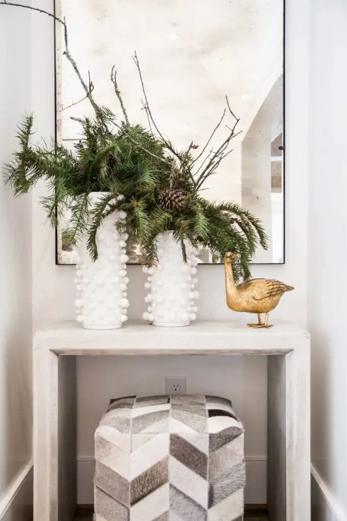 Holiday vignette with fir tree branches in white vases on Thou Swell @thouswellblog