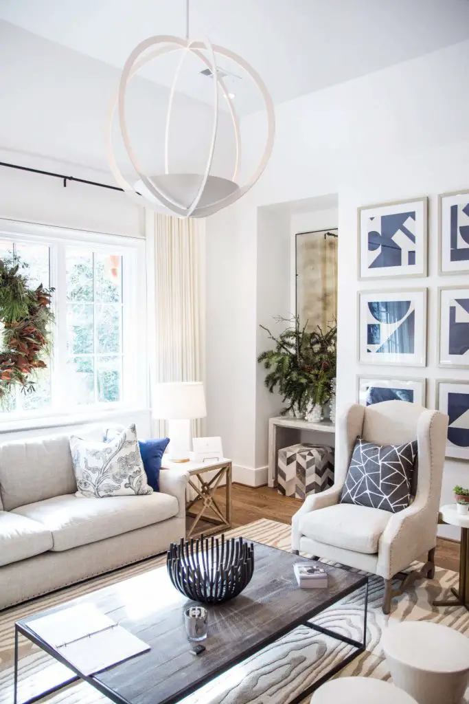 White neutral living room with wreath in the window on Thou Swell @thouswellblog