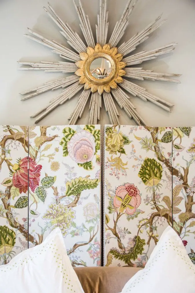 Floral folding screen and starburst mirror behind bed on Thou Swell @thouswellblog