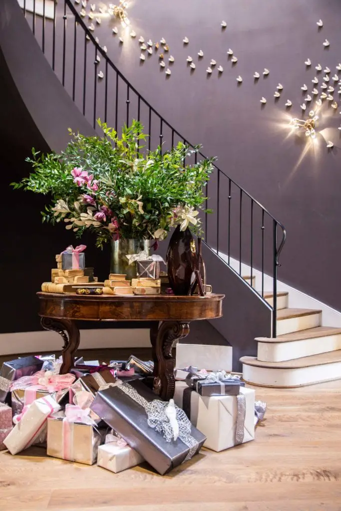 Round entryway with dark walls and Christmas presents under the table on Thou Swell @thouswellblog