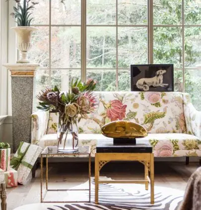 Light-filled sitting area with floor to ceiling windows and floral sofa on Thou Swell @thouswellblog