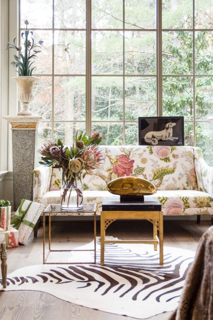 Light-filled sitting area with floor to ceiling windows and floral sofa on Thou Swell @thouswellblog