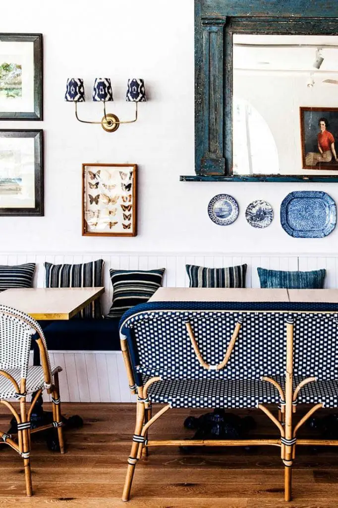 Blue and white banquette dining with gallery wall and sconce light on Thou Swell @thouswellblog