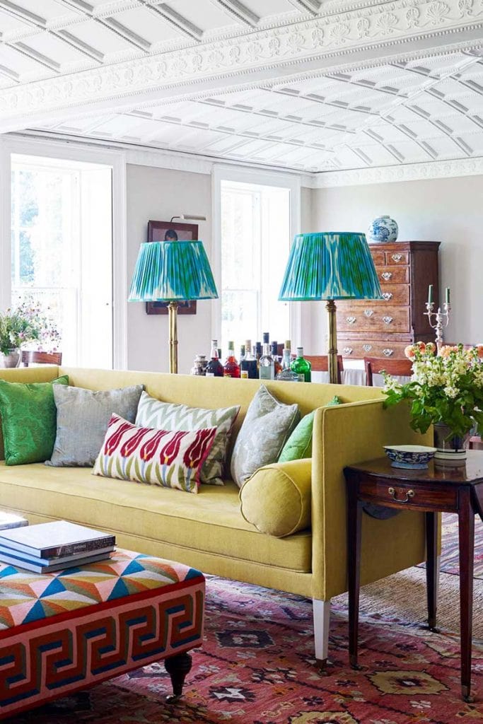 Colorful living room with teal patterned lampshades and yellow sofa on Thou Swell @thouswellblog