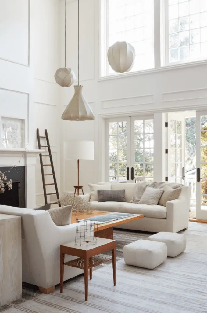 Serene cream living room with all-white upholstery and pendant lights on Thou Swell @thouswellblog