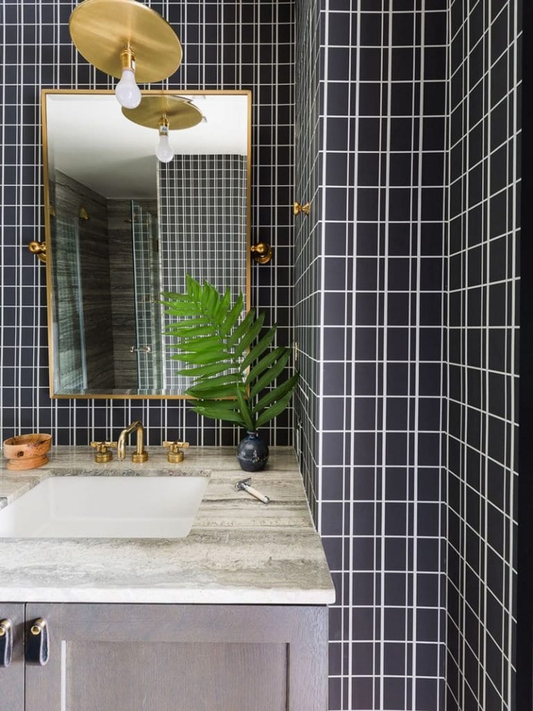 Modern bathroom with black and white grid tile and gold pendant above weathered grey vanity on Thou Swell @thouswellblog