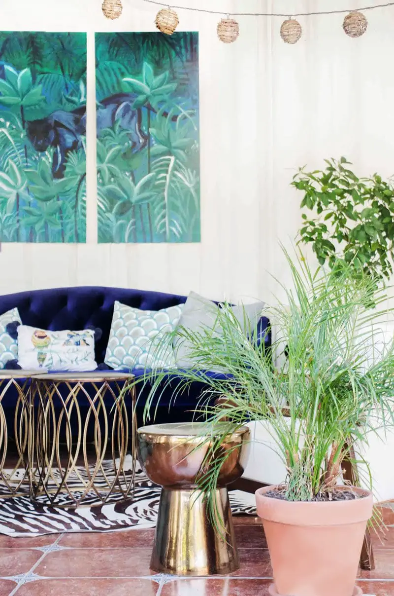 Tropical sun room with blue velvet sofa and indoor plants on Thou Swell @thouswellblog