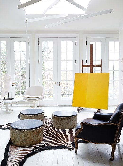 Stunning white sunroom with yellow painting and zebra rug on Thou Swell @thouswellblog