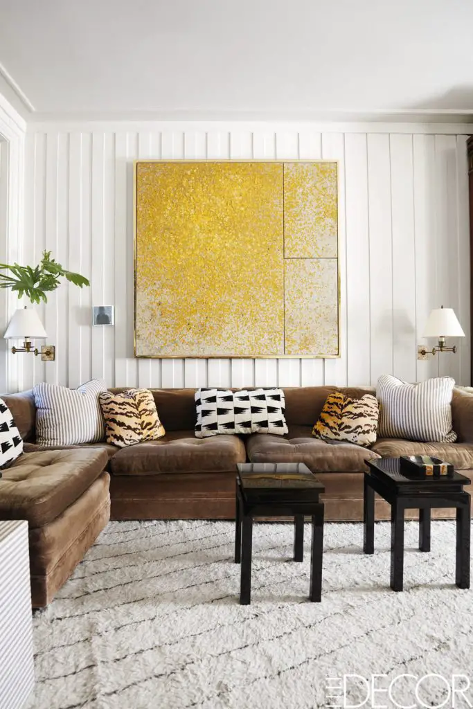 Bright family room with yellow painting and brown sectional on Thou Swell @thouswellblog