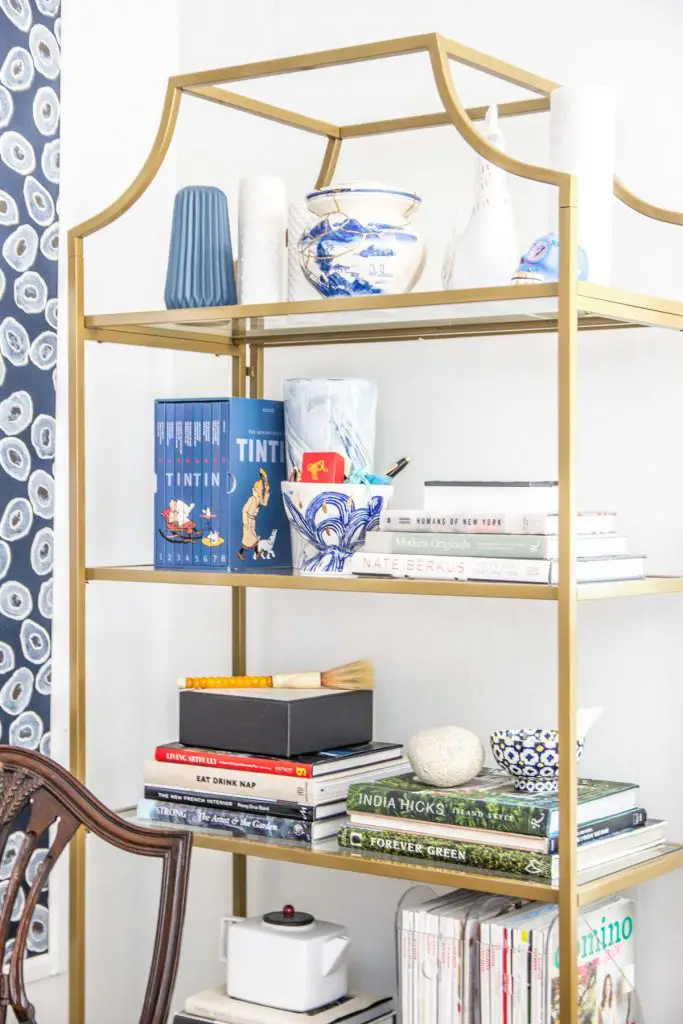 A more creative and inspiring workspace with blue wallpaper panels, modern white desk, and gold bookcase on Thou Swell @thouswellblog